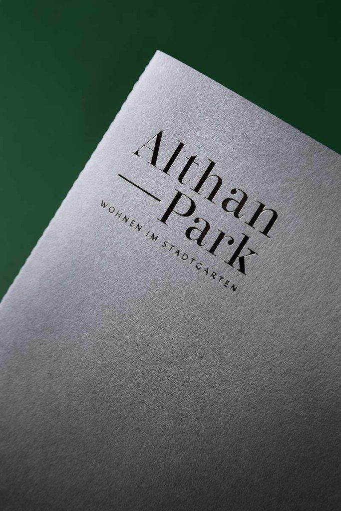 Immobilienprojekt Althan Park Broschüre vor grünem Hintergrund fotografiert von Produktfotograf aus Wien Clemens Schneider